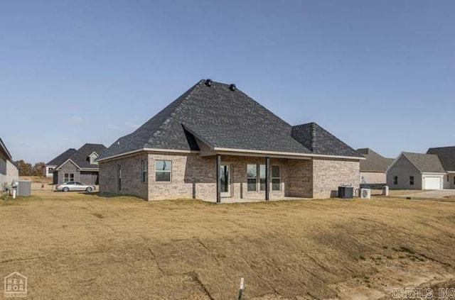 rear view of house featuring a lawn