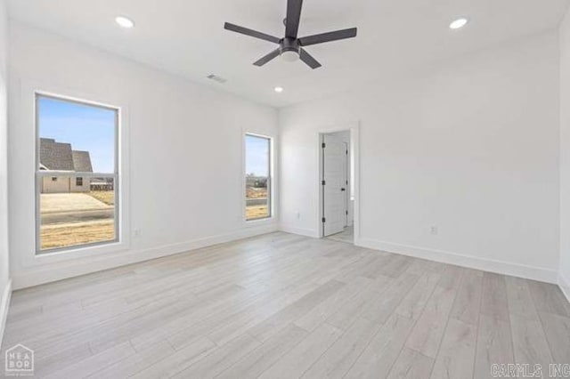 spare room with light wood-type flooring and ceiling fan