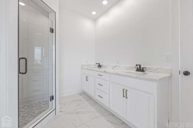 bathroom with vanity and a shower with shower door