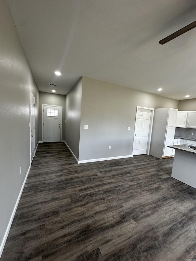 interior space featuring light countertops, dark wood-type flooring, visible vents, and white cabinets