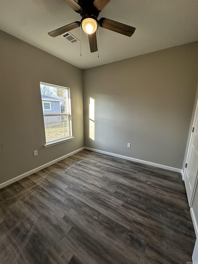 unfurnished room with ceiling fan and dark hardwood / wood-style floors