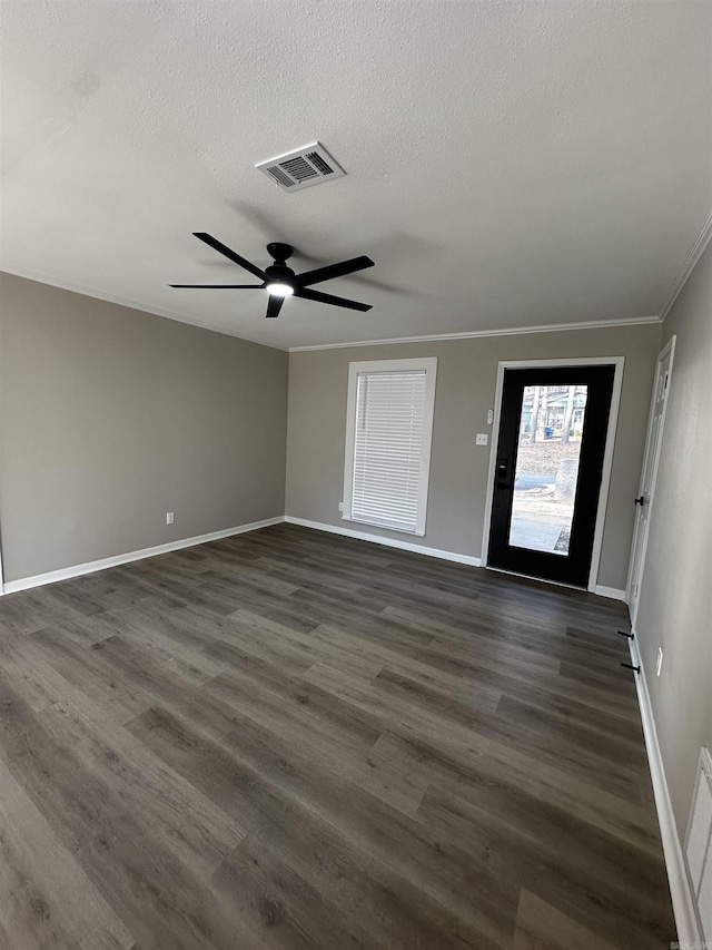 entrance foyer with ceiling fan, dark hardwood / wood-style flooring, ornamental molding, and a textured ceiling