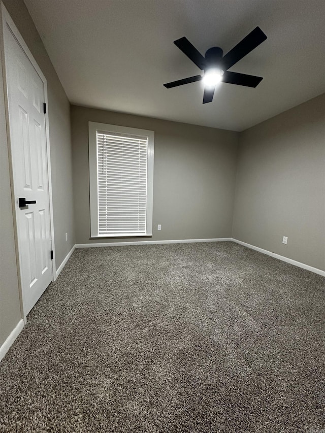 empty room featuring carpet floors and ceiling fan