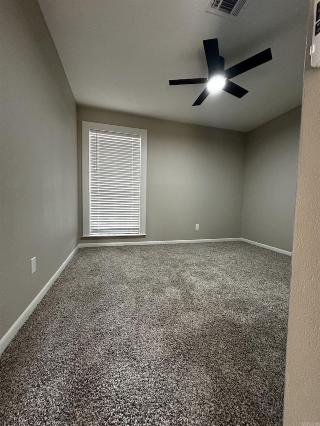 carpeted spare room with ceiling fan