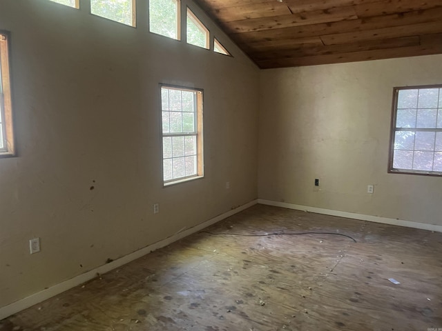 unfurnished room with wooden ceiling, a wealth of natural light, and vaulted ceiling