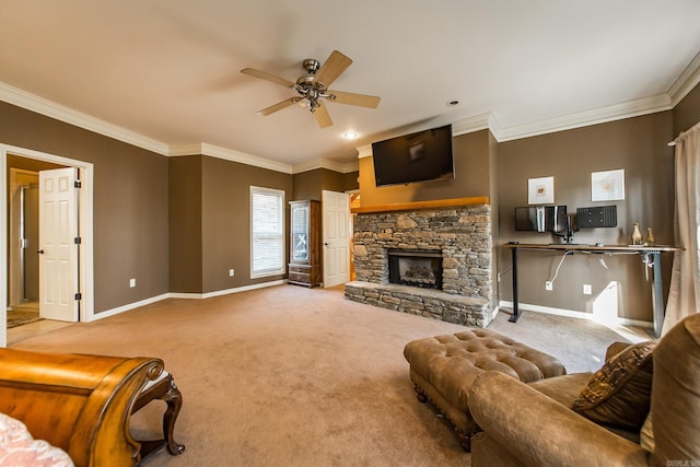 carpeted living room with ceiling fan, a stone fireplace, and ornamental molding