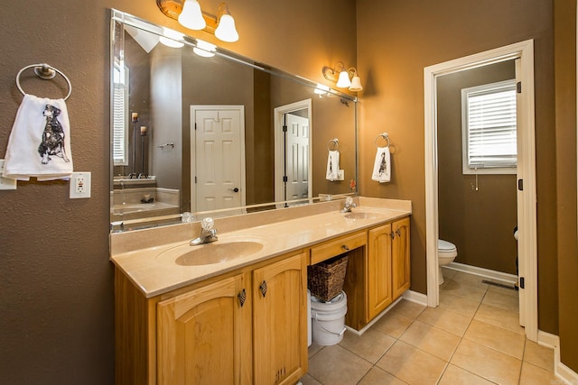 bathroom with tile patterned floors, vanity, and toilet