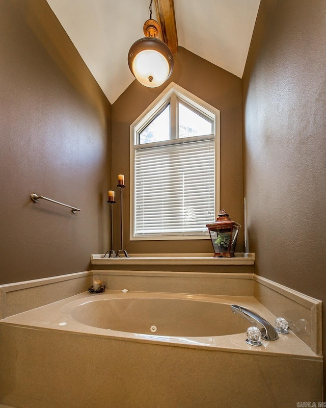 bathroom featuring a tub and vaulted ceiling