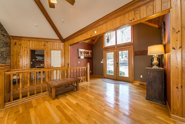 interior space featuring ceiling fan, french doors, high vaulted ceiling, beamed ceiling, and light hardwood / wood-style floors