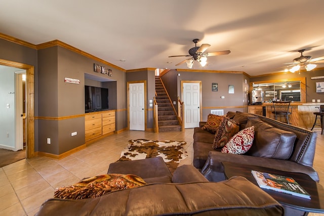 living room featuring ceiling fan, light tile patterned floors, and crown molding