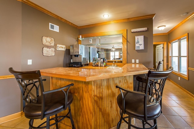 bar with crown molding, tile patterned flooring, and ceiling fan