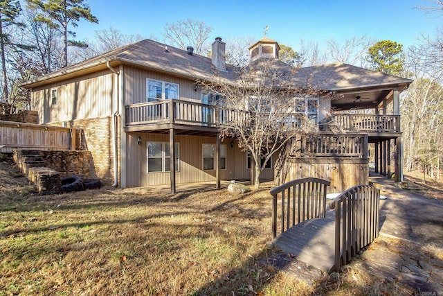 rear view of house with ceiling fan and a deck