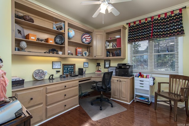 office area featuring crown molding, dark wood-type flooring, and built in desk