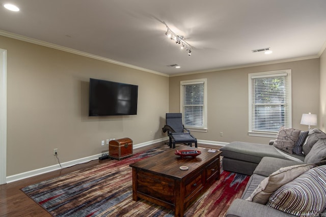 living room featuring dark hardwood / wood-style floors, crown molding, and track lighting