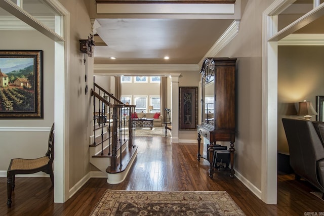 entrance foyer with dark hardwood / wood-style floors and crown molding