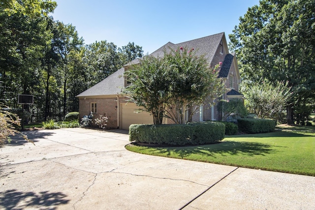 view of property exterior featuring a garage and a lawn