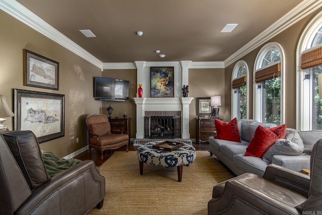 living room with ornamental molding and a brick fireplace