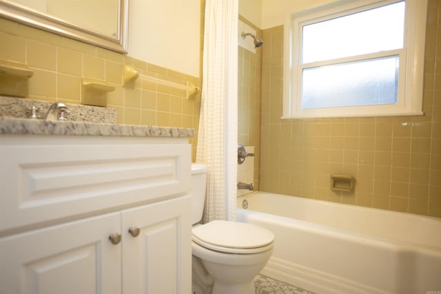 full bathroom featuring sink, shower / tub combo, tile walls, and toilet