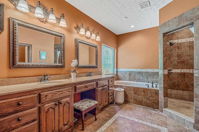 bathroom featuring vanity, shower with separate bathtub, a textured ceiling, and tile patterned flooring