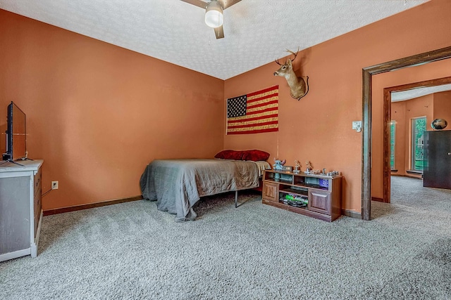 carpeted bedroom with a textured ceiling and ceiling fan