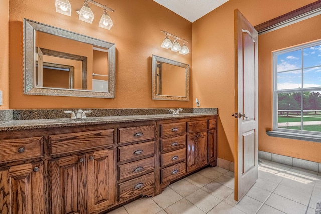 bathroom with tile patterned flooring and vanity