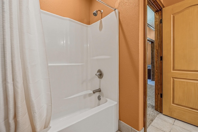 bathroom featuring shower / bath combo with shower curtain and tile patterned flooring