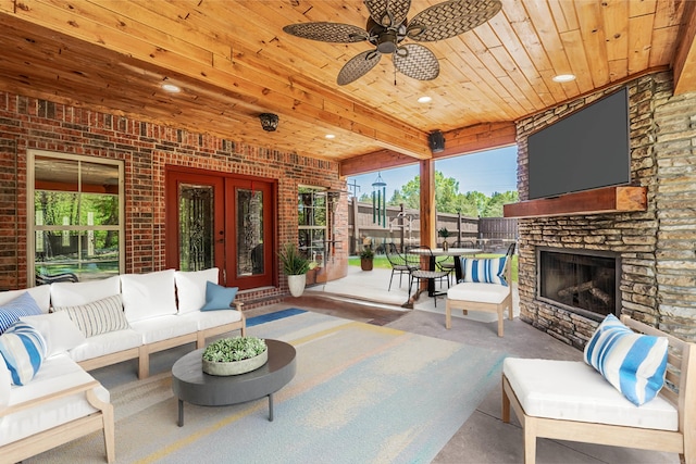 view of patio featuring ceiling fan and an outdoor stone fireplace