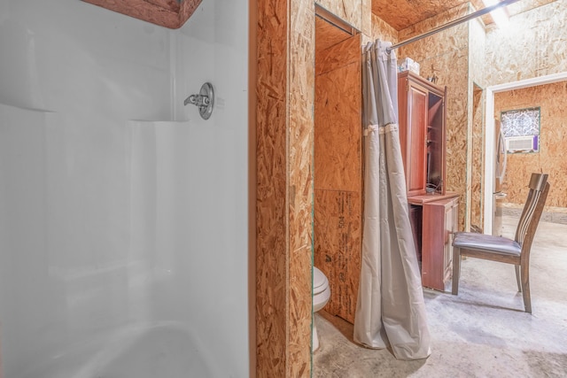 bathroom with a shower with shower curtain and toilet