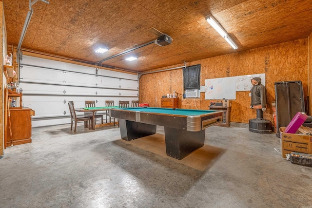 rec room featuring wooden walls, cooling unit, concrete flooring, and pool table