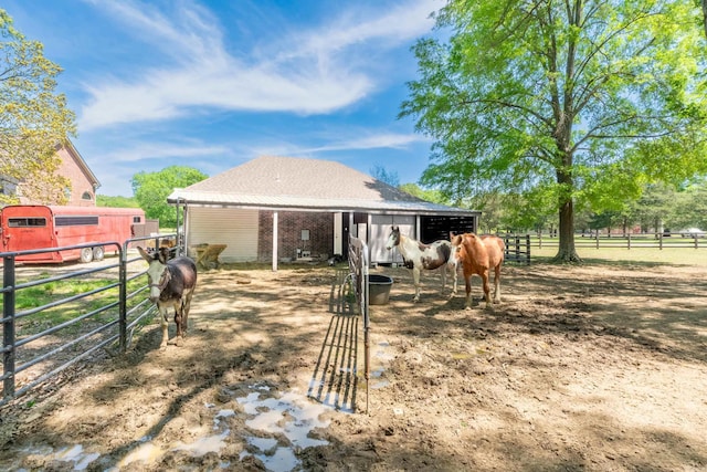 view of horse barn featuring a rural view