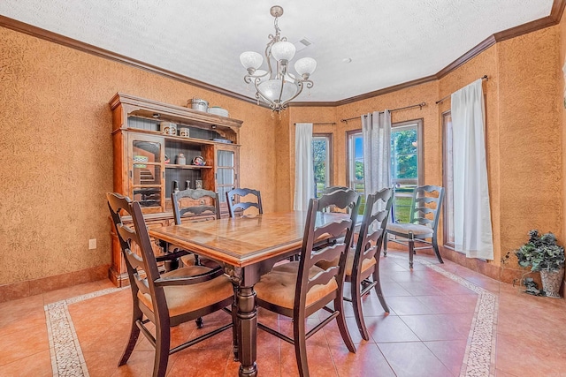 tiled dining area with a chandelier, a textured ceiling, and crown molding