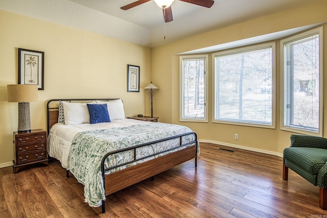 bedroom with ceiling fan and dark hardwood / wood-style flooring