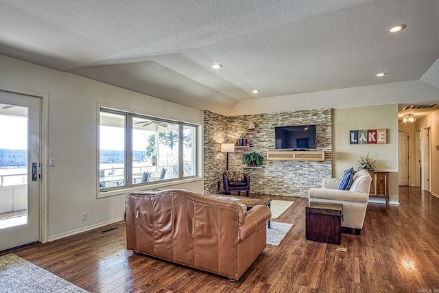 living room featuring a textured ceiling, dark wood-type flooring, and vaulted ceiling