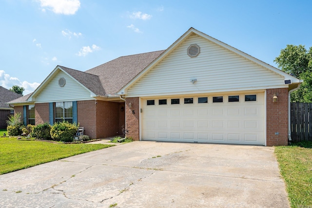 single story home featuring a front yard and a garage