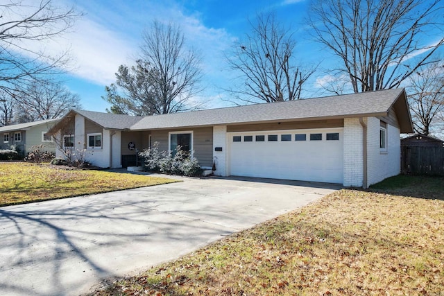 ranch-style home featuring a garage and a front lawn