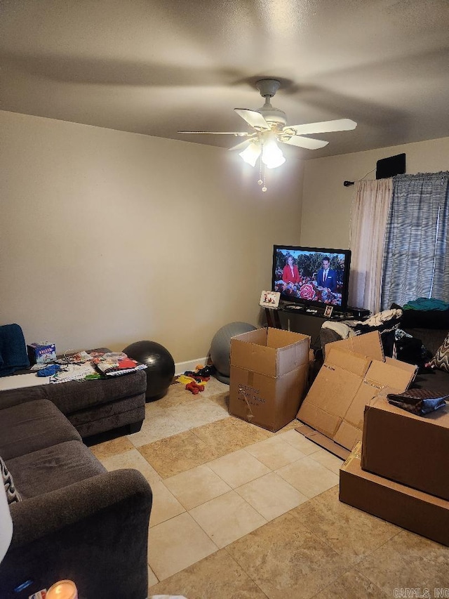 living room with ceiling fan and light tile patterned flooring