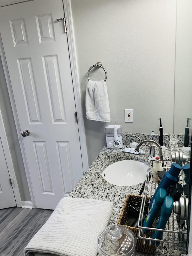 bathroom with hardwood / wood-style floors and vanity