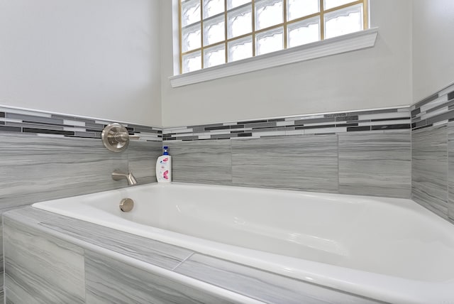 bathroom featuring a relaxing tiled tub