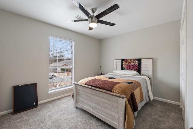 carpeted bedroom with multiple windows and ceiling fan