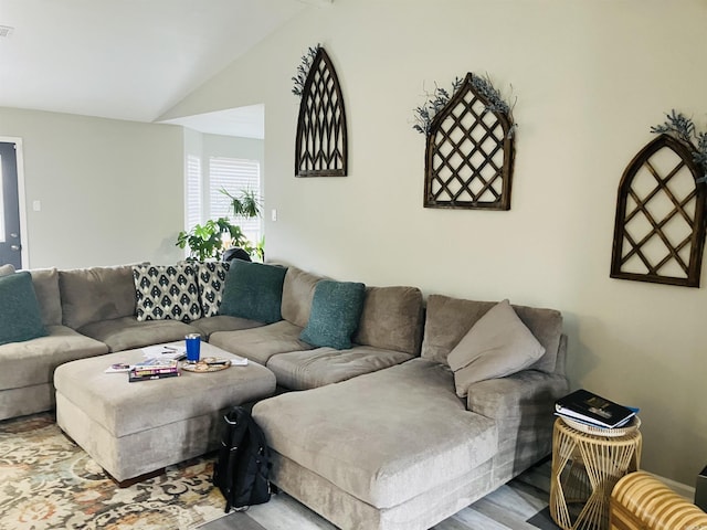 living room featuring vaulted ceiling and light hardwood / wood-style flooring