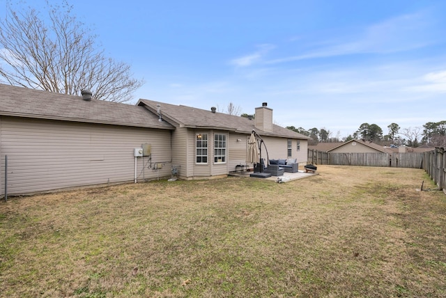 back of house featuring a yard, outdoor lounge area, and a patio