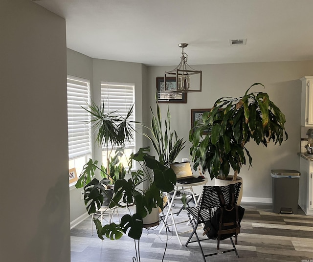 dining area featuring dark wood-type flooring and a wealth of natural light