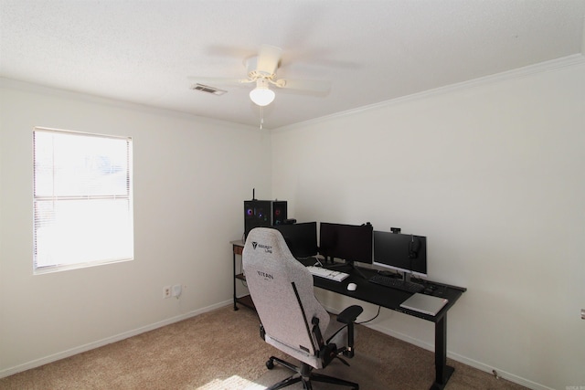 home office with carpet flooring, ceiling fan, and crown molding