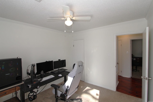 office space with a textured ceiling, ceiling fan, carpet floors, and ornamental molding