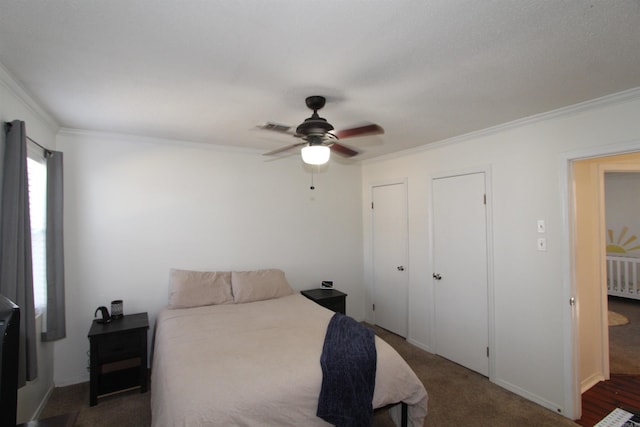 bedroom featuring ceiling fan, dark carpet, and ornamental molding