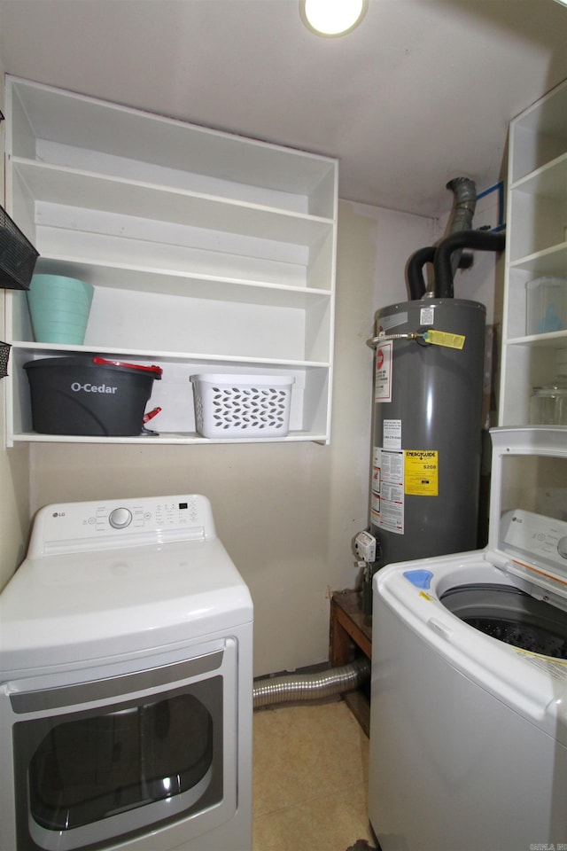 clothes washing area featuring washer and clothes dryer and gas water heater