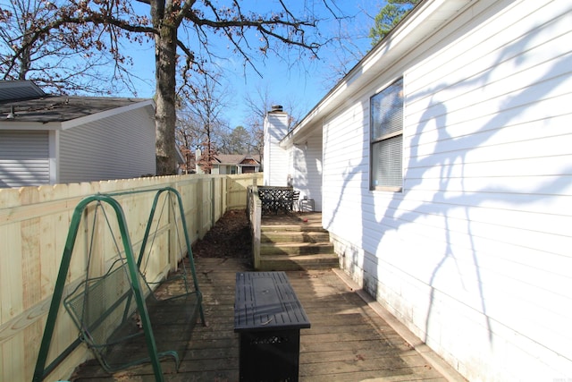 view of side of property with a wooden deck