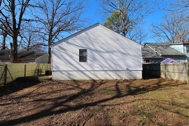 view of side of home with a yard