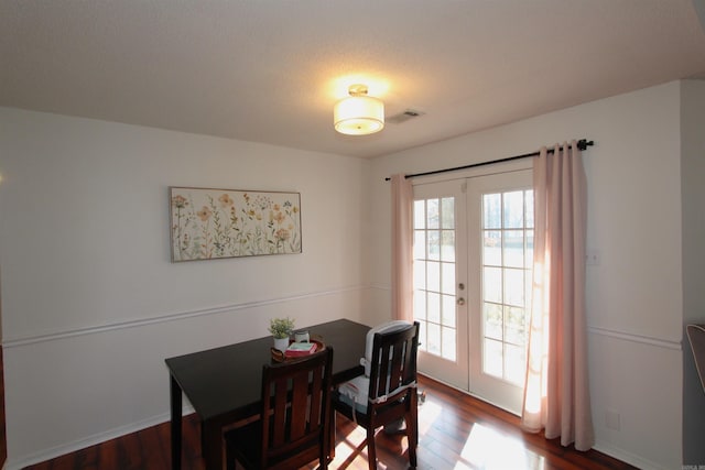 dining space with french doors and wood-type flooring