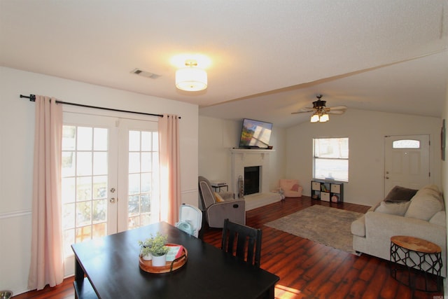 dining space with ceiling fan, dark hardwood / wood-style floors, and vaulted ceiling